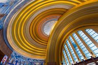 The rotunda features a seemingly unlikely whispering gallery. The east wall's arch around its windows features decorated flues, elements typical in Art Deco design. The flues act as sound channels, allowing people 30 meters apart at the base of each arch, by symmetrical drinking fountains, to hold a private conversation with ease. -- Wikipedia 