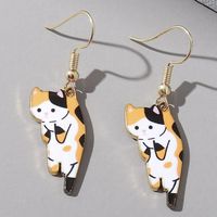 #ad These calico cat earrings look like someone is holding it by the scruff. #calicocats #cats #earrings