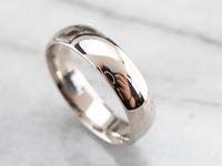 This men's wedding band is well-designed for comfort and wearability. Classic and simple, this 14 karat white gold ring has a comfort fit design that puts less pressure on your finger when worn, making it perfect for everyday wear. Clean and polished, this band is built to last! Metal: 14K White Gold Width of Band: 5.8 mm Height off Finger: 2 mm Ring Size: 11.25 Marks: "14K" Stamped on the inside band