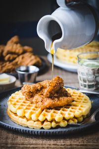 This quick weeknight chicken and waffles recipe includes crispy chicken tenders, hearty cornbread waffles, and a drizzle of maple syrup, honey, or powdered sugar. The combination is sweet, savory, and perfect for breakfast, brunch, lunch, or dinner!