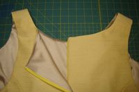 What is a good method for finishing the seam above a zipper?  The goal is to have a sharp corner, keep fabric away from the zipper teeth, and reduce bulk.  This yellow dress has a lined bodice and inv