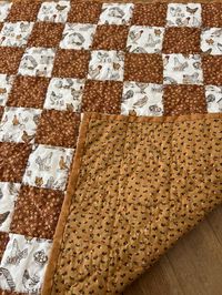 This small quilt features a chicken print fabric. It is set in a checkerboard pattern with a coordinating small-scale floral print. It is backed and bound with coordinating fabrics. All piecing and quilting is by hand. This would make a cute wall hanging, table topper or go on a chair back. Great gift for that chicken collector in your life.