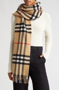 A bold archival check lends signature distinction to a supremely soft cashmere scarf tipped with slim fringe. 79" x 20"; 3" fringe 100% cashmere Dry clean Made in the UK