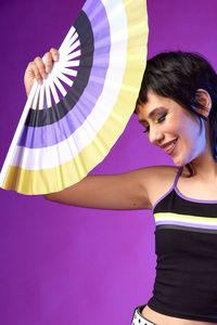 Celebrate your identity with this Non-Binary Flag Fan! Featuring yellow, white, purple, and black, this handy fan represents the non-binary pride flag. Keep yourself cool and create a stunning display of equality with this vibrant fan.