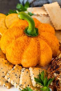 This pumpkin cheese ball is a blend of cheeses and seasonings that is shaped like a pumpkin and coated with crunchy cheese cracker crumbs.