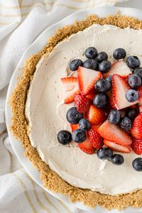 This quick and easy No Bake Cheesecake with Cool Whip is a smooth and creamy dessert that’s perfect any time of year. Top with seasonal fresh berries or your favorite fruit pie filling and you’ll have a crowd-pleasing summer dessert that's always a hit!