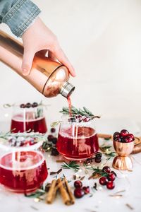 Mrs. Claus cocktail - a blend of cranberry juice, whiskey, cinnamon sticks