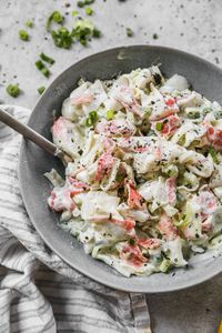 This creamy crab salad is a lighter version of the original with no mayo! Fresh herbs and lemon make it bright. The best imitation crab salad recipe!