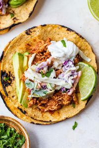 Easy Rotisserie Chicken Tacos are made with seasoned rotisserie chicken and a simple cilantro-lime cabbage slaw for an tasty weeknight meal. 