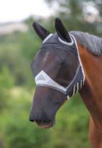 Shires Fine Mesh Fly Mask With Detachable Nose and Air Stream Ears. A full face mesh fly mask complete with air stream fabric on the ears provides flexible protection against flies. Complete with fleece padding along the seams. Ergonomic shaping and fleece padding along the seams keeps the fly mask away from the eyes and reduces gaps. The addition of the detachable (zipper) nose helps deter flies from the muzzle area. Adjustable touch close safety straps allow for a snug fit. Hand wash cool - Li