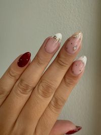 Thanksgiving nails inspo, holiday nails 2024, holiday inspo nail designs, bow design nail inspo, nail design inspo, nail design with rhinestones, red and french tip nails, gold bow nails, almond nail designs