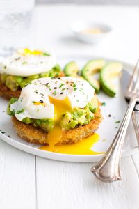 Fried Green Tomatoes with Avocados and Poached Eggs - slices of green tomatoes get coated and lightly fried until they're golden brown and crunchy on the outside and just barely soft on the inside. Then they're topped with some mashed avocado and poached eggs. Perfect for breakfast, lunch or dinner! | tamingofthespoon.com