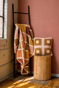 Made with bulky yarn, this afghan and pillow set works up fairly quickly. This matching set will make you want to grab a good book and a cup of tea and stay in for the evening! The blanket is a 52” square, and the pillow is an 18” square.Designer: Toni LipseyYarn weight: BulkySuggested yarn: Lion Brand Hue + Me