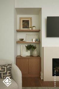 Simple, seamless, and full of natural warmth. 🔥✨ this living room features stunning white oak touch-and-release cabinets on either side of the fireplace, perfectly paired with white oak floating shelves above. #LivingRoomCabinet #LivingRoomDesign #WhiteOak #FloatingShelf