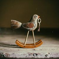 "Bird with key on rockers"