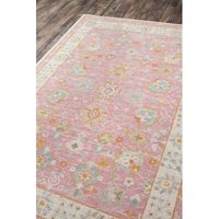 The gentle pastels and classic motif of this decorative pink area rug add instant comfort and style to your child’s room. A rug keeps little feet warm on chilly mornings and softens the sound of those same little feet throughout the day. This all-over print area rug is power-loomed from an innovative combination of wool and nylon, and it's low .25” pile height makes it easy to vacuum and clean. We suggest pairing it with a rug pad to prevent shifting and add even more cushiness. Rug Size: Rectan