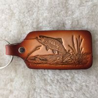 Each key tag is handcrafted with every detail of the art permanently imprinted through our unique process requiring 25 tons of pressure. The top grain leather is then hand finished for added beauty and endurance. All wildlife images are original artwork commissioned specifically for these items. Dimensions 3 1/2" X 1 3/4" Choose to display this rugged piece yourself or gift it to the fisherman, hunter, hobbyist, or outdoor adventurer in your life.  Ask us how we can put your artwork or logo on this item!! (Send a message for details).