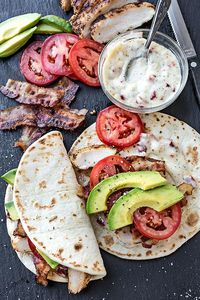 Sandwiches don't always have to mean two slices of bread - why not try this recipe for smokey chicken flatbread with crispy bacon, avocado and sundried tomato mayonnaise #BritishSandwichWeek