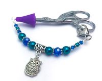 This cobalt blue and teal beaded scissor fob decorates your scissors, makes them easy to spot when searching, and with the rubber tip cover it makes them safe to take on the go.  You choose to order with or without a scissor tip cover and with or without a scissors. PLEASE LOOK AT OPTIONS DROP DOWN BOX. Spend less time searching for your scissors.  These can also be used as: - zipper pull jewelry  - key chain charms  - beaded rear view mirror ornaments Go ahead be creative with them! YOU MAY ALS