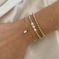 14k Gold filled - Handcrafted- Hypoallergenic- Waterproof This cute bracelet features 14k gold filled beads and 3 white freshwater pearls. Hand strung on a stretchy band. Made in California.