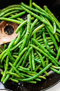 This sautéed green beans recipe is such a quick and easy side dish that cooks up in under 15 minutes! Fresh green beans are sautéed with garlic and a few seasonings until crisp-tender.