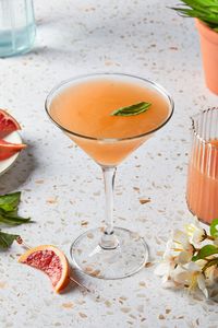 This basil grapefruit martini is made with fresh grapefruit juice and vodka, sweetened slightly and shaken with fresh basil leaves. It's tangy and refreshing, with a subtle pop of aromatic basil for an elegant and invigorating drink.