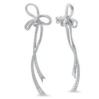 Long Bow Earrings The Atame Collection is the physical embodiment of the liaison between lovers; totally attached, very fluid and romantic. “Atame” meaning “tie me up” in Spanish, is all about lovers sharing a life, while equally being tied up in one another. 18-karat white gold earrings Set with 3.38 ctw white diamonds Measurements 2.4 cm wide by 7.7 cm long Brilliant Cut Color: H-G Clarity: VS1-VS2 Conflict free diamonds Ships Immediately