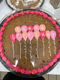 large chocolate chip cookie decorated with buttercream icing