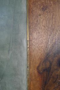 Metal transition strip between concrete and wood