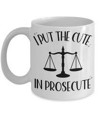 Looking for the perfect gift for a law student or lawyer? Look no further than i put the cute in prosecute mug! This hilarious gift is perfect for anyone who loves to laugh. It's the perfect way to show your support and celebrate their upcoming graduation. Plus, it makes a great gag gift for any bar exam party! This high quality 11 or 15 ounce ceramic coffee mug is the perfect novelty gift for anyone and everyone.  Great for not only coffee, but also tea, hot chocolate, milk or any beverage with its large, easy to grip C-handle. ☕ Mugs crafted from the highest grade ceramic, available in 11 and 15 oz. ☕ Design printed using a sublimation process making the design part of the mug surface. ☕ Prints are high quality and won't scratch, peel or fade away over time. ☕ Design printed on both fron