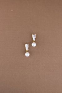 The Gorgeous DARA Earrings with Swarovski & Cubic Zirconia Crystals and Pearls are Absolutely Beautiful. They are long and beautiful to give you that elegant look. They can be styled with most of our wedding headpieces and Bridal Tiaras and Crowns for a majestic and elegant look. Handcrafted Highest Quality Swarovski / Cubic Zirconia Platinum plated Guards against scratches and tarnish. approximate size 1.25" length 0.5" width Nickel free Free Shipping in USA