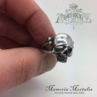 Alchemy Memoria Mortalis Ring⠀ Was £11.99 Now £5.99⠀ ⠀ The ultimate gothic accessory - a small, realistic, polished pewter skull ring on a split shank modelled as bones.⠀ ⠀ Want to see more? Website link is in our Bio!⠀ ⠀ #AlchemyGothic #AlchemyEngland #AlchemyRing #AlchemySale #Ring #SkullRing #AlternativeRing #AlternativeJewelry #Alternative #Lifestyle #Goth #Gothic