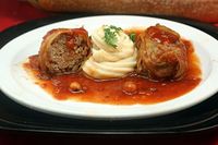 Amazing Stuffed Cabbage Rolls. Tender leaves of cabbage stuffed and rolled with beef, garlic, onion and rice, simmered in a rich tomato sauce.