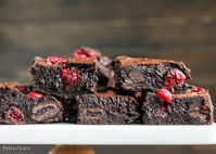 These Cranberry Brownies are made with dark chocolate, fresh and dried cranberries, and dark chocolate covered cranberries! You'll love this unique recipe.