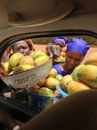 Mangos season! Vendors fighting to sell mangos to travellers inside their car... Senegal