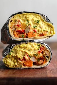 Delicious and easy to make Vegan Breakfast Burritos are loaded with tofu scramble, vegan queso and easy potato veggie hash. They freeze perfectly for quick and filling weekday morning breakfasts!