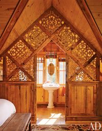 A "choir screen" separates the bedroom and a sitting area from a bath in a Norwegian-style boathouse in Colorado.