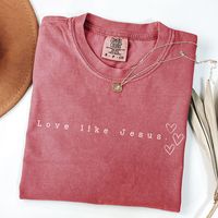 Boasting a simple style with a meaningful message, the Love Like Jesus Tee is an ideal shirt for church gatherings, baptism ceremonies, or ANYWHERE (let's spread the love of Jesus and is a thoughtful religious gift for the Christian women in your life. This design can also be found on a sweatshirt here: https://withawildflowerllc.etsy.com/listing/1633581666 With A Wildflower aims to blend faith and fashion, focusing on minimalist and boho styles. Comfort Colors tees are super soft and super comf