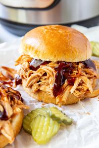 This Instant Pot BBQ Chicken is saucy, tender, and so easy to make. This Instant Pot pulled chicken makes the BEST BBQ chicken sandwiches!