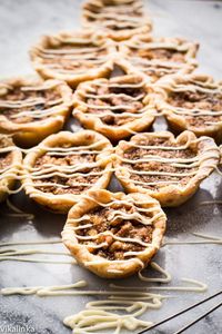 Flaky mini pastry tarts filled with delicious custard, raisins and walnuts. These maple butter tarts are delicious!