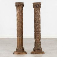 Pair of antique wood carved Gothic Revival architectural Columns  Anonymous 19th century; Belgium or Netherlands Wood  Approximate size: 41.75 (h) x 11.75 (w) x 11.75 (d) in.  An exceptional pair of tall and intricate hand carved vintage wooden 19th century church columns.  The handsome aged patina coupled with the masterful carving elevates these decorative objects-of-art with a brilliant texture and ambiance. Likely salvaged from an old Belgian or Netherlandish church, we are led to assume the