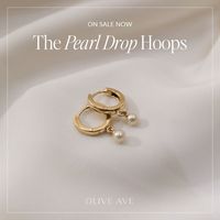 14K Yellow Gold | Pearl Drop Hoops feature a classic gold hoop with a dangling 3.5mm cultured seed pearl with a hinged post closure.