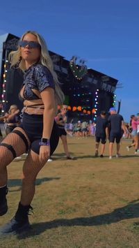 This rave babe is a shuffle star! She looks amazing dancing in our Hellcat set. She paired the sparkly flame bikini top with a tiny tee crop top and black bike shorts.