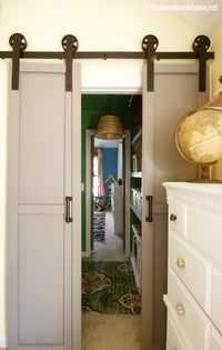 Two narrow sliding barn doors could make a tidy replacement for our pocket door that's forever coming off-track...