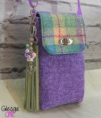 "Handmade Harris Tweed Tartan Midi Crossbody Phone Bag lightweight bag for those occasions when you only want to carry your phone and the essentials. Harris Tweed tartan bag in lovely colours of lilac, teal, cream and magenta. I've used many, many Harris Tweed tartans over the years and I have to say I think this one is arguably the prettiest.  Woven by independant weavers (Little Shop of Harris Tweed) on the Island of Harris it is simply delicious .... when I look at it I think of sunny days at the seaside and neapolitan ice cream.  These phone bags were a joy to sew and make me smile every time I look at them ... they're just so pretty and I'm sure it will be the same for everybody else; making them a perfect gift. The bags are made from Harris Tweed on the exterior and lined with teal h