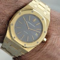 Sporty luxury, Men's solid 18k gold Audemars Piguet Royal Oak Ref.5402BA, limited to 736 units, c.1990s, with receipt and original box, in excellent, original condition. Verified authentic by a master watchmaker. Classic Audemars Piguet grey tapisserie dial, applied indice hour markers, AP logo at the 12, gilt minute and hour hands, date display at the 3 o'clock position, hands and dial in excellent, original condition. Sapphire crystal. 18k solid gold bezel on solid 18k case, case measures 39.5mm wide, 7mm thin. Original Audemars Piguet unsigned octagonal gold crown. 36-jeweled Audemars Piguet cal.2121 self-winding movement, cleaned, in excellent running condition. On original Audemars Piguet 18k gold bracelet, measures 7 1/2 inches, in excellent condition. Watch and bracelet all original