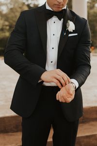 | white groom's boutonniere | bohemian groom style | classy boho groom style | formal bohemian groom style | modern groom style | traditional groom style | groom portrait ideas | groom in a black suit + black tie | wedding style | photo taken at THE SPRINGS Event Venue. follow this pin to our website for more information, or to book your free tour! SPRINGS location: Tuscany Hill in McKinney, TX photographer: Ashia Mosley Photography #groom #weddingstyle #weddingphotography #bohowedding #wedding