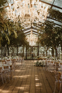 Light spilled through towering oak trees creating ethereal ambience for Stefan and Gabrielle’s South African wedding inside a glass conservatory.