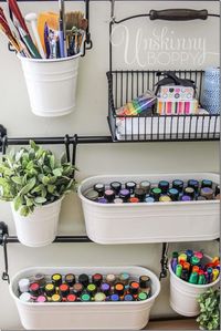 Store art supplies in hanging buckets for easy craft room organization.