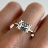 The Posey East/West Engagement Ring sounds dainty; however, she is anything but. This emerald cut ring looks amazing in a wedding stack—our latest Black Diamond Collection features several rings that complement the shape of this stackable engagement ring. 2ct engagement ring shown in pictures.